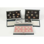 FOUR UK PROOF COIN SETS IN DELUXE CASES, 1983, 1985, 1986, together with a CASED SET OF TWELVE