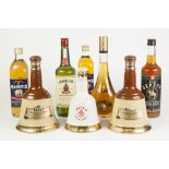 TWO 75cl BOTTLES OF BELL'S BLENDED SCOTCH WHISKY IN BELL SHAPED POTTERY BOTTLES, together with