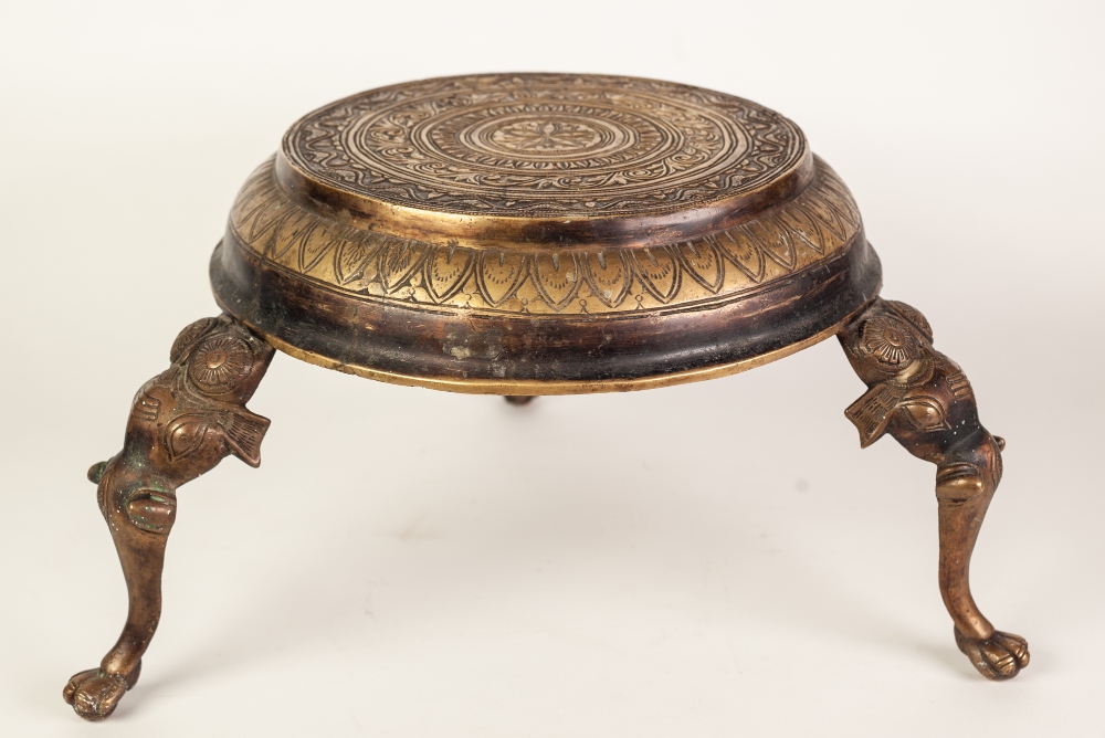 INDIAN CAST AND ENGRAVED BRASS THREE LEGGED STAND, the circular top profusely decorated with bands - Image 2 of 3