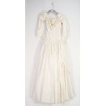 WHITE POLYESTER NYLON FULL LENGTH WEDDING DRESS, with floral applique round the necklace, puff