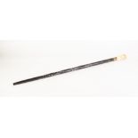A LATE NINETEENTH CENTURY ANGLO-INDIAN EBONY SPIRALLY CARVED AND BONE INLAID WALKING STICK, the