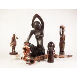 THREE AFRICAN CARVED WOOD FIGURES, including one in rosewood, 'The Head of Pride' modelled as a