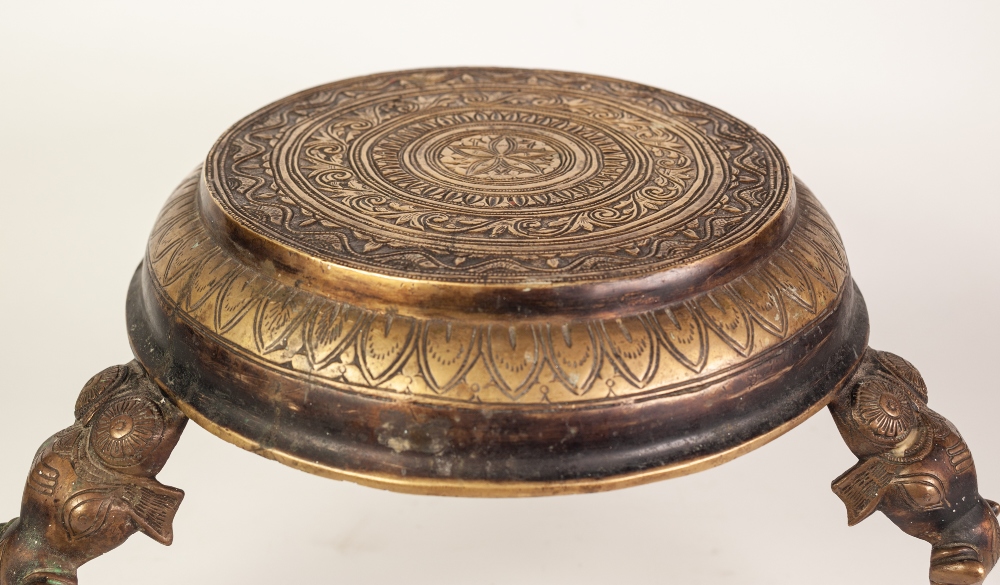 INDIAN CAST AND ENGRAVED BRASS THREE LEGGED STAND, the circular top profusely decorated with bands - Image 3 of 3