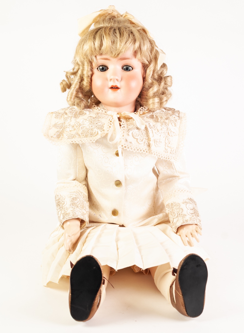 AN EARLY TWENTIETH CENTURY SIMON AND HALBIG BISQUE HEAD DOLL with sleeping blue eyes and open mouth,