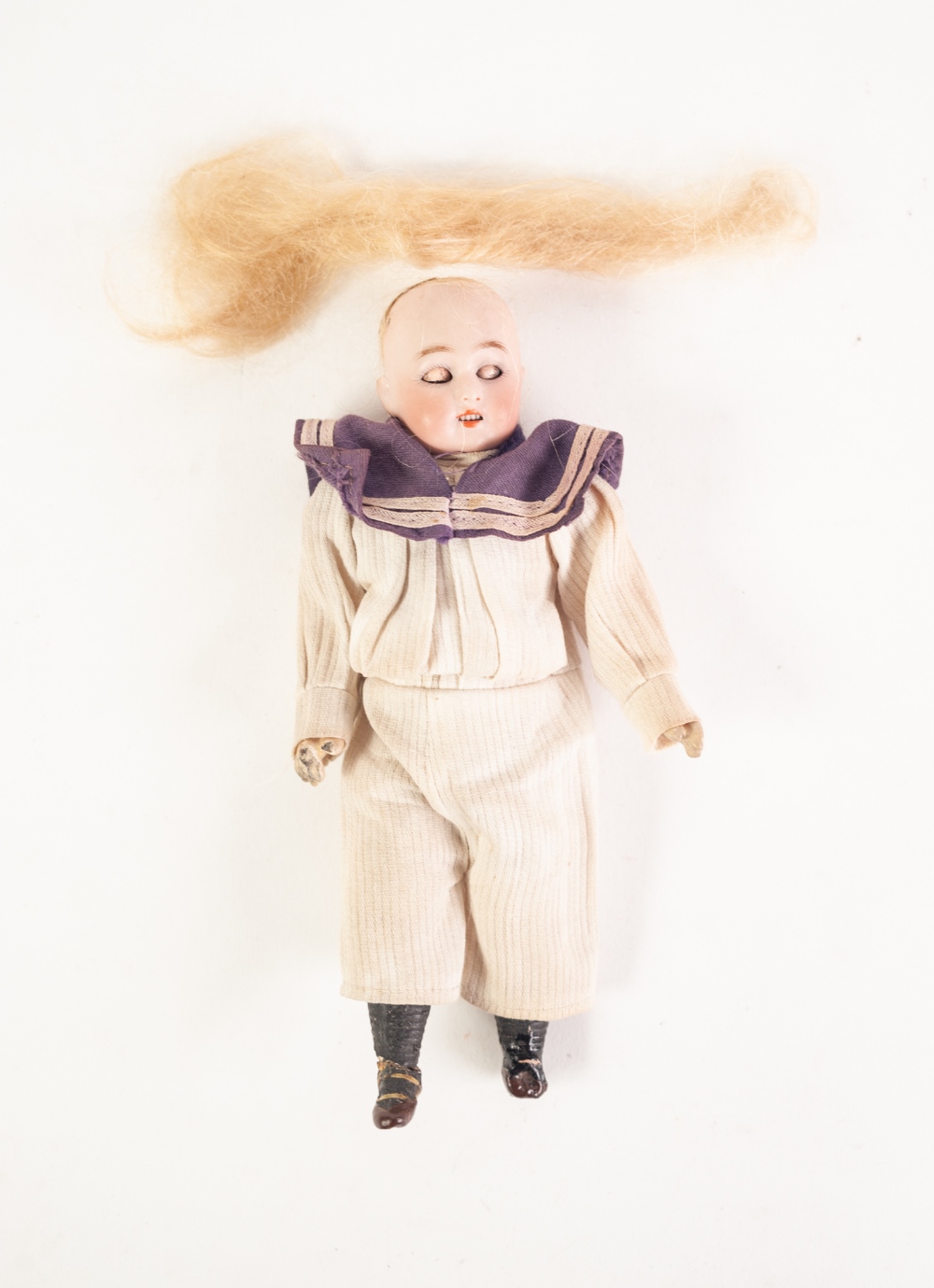 A SMALL HARTMANN D.E.P. BISQUE HEAD 'GLOBE BABY' DOLL in original sailors clothing, composition body