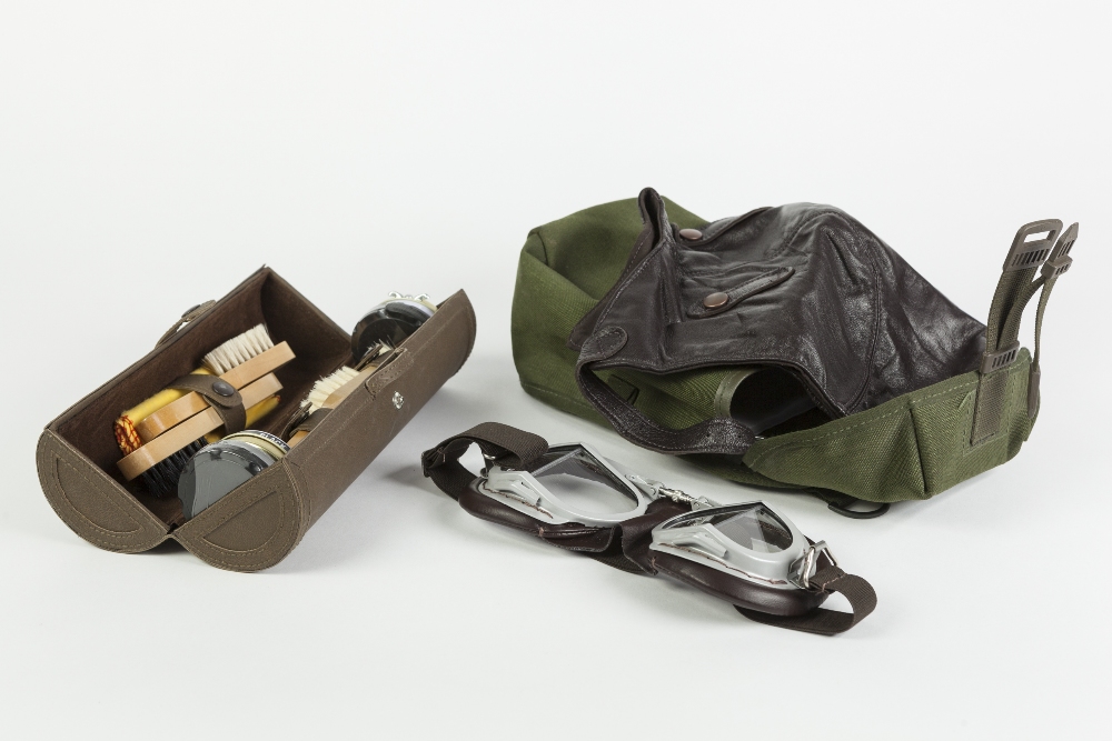 AN AVIATOR GOGGLES, LEATHER HELMET AND WHITE SILK SCARF, for Vintage aircraft flying; with green