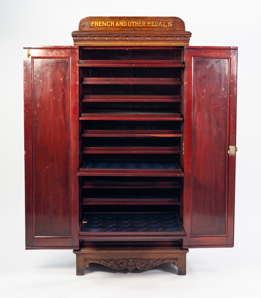 EARLY TWENTIETH CENTURY CARVED MAHOGANY MEDAL COLLECTORS CABINET, the moulded oblong top above a - Image 2 of 2