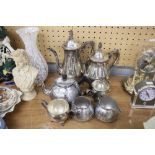 A SILVER PLATE TEA/COFFEE SERVICE OF FOUR PIECES AND ANOTHER OF THREE PIECES