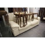 A THREE SEATER MODERN CREAM LEATHER SOFA