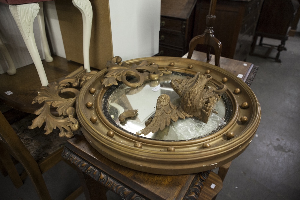 A LARGE GILT FRAME CONVEX WALL MIRROR, WITH EAGLE PEDIMENT (A.F.) AND A SMALL MAHOGANY TRIPOD WINE