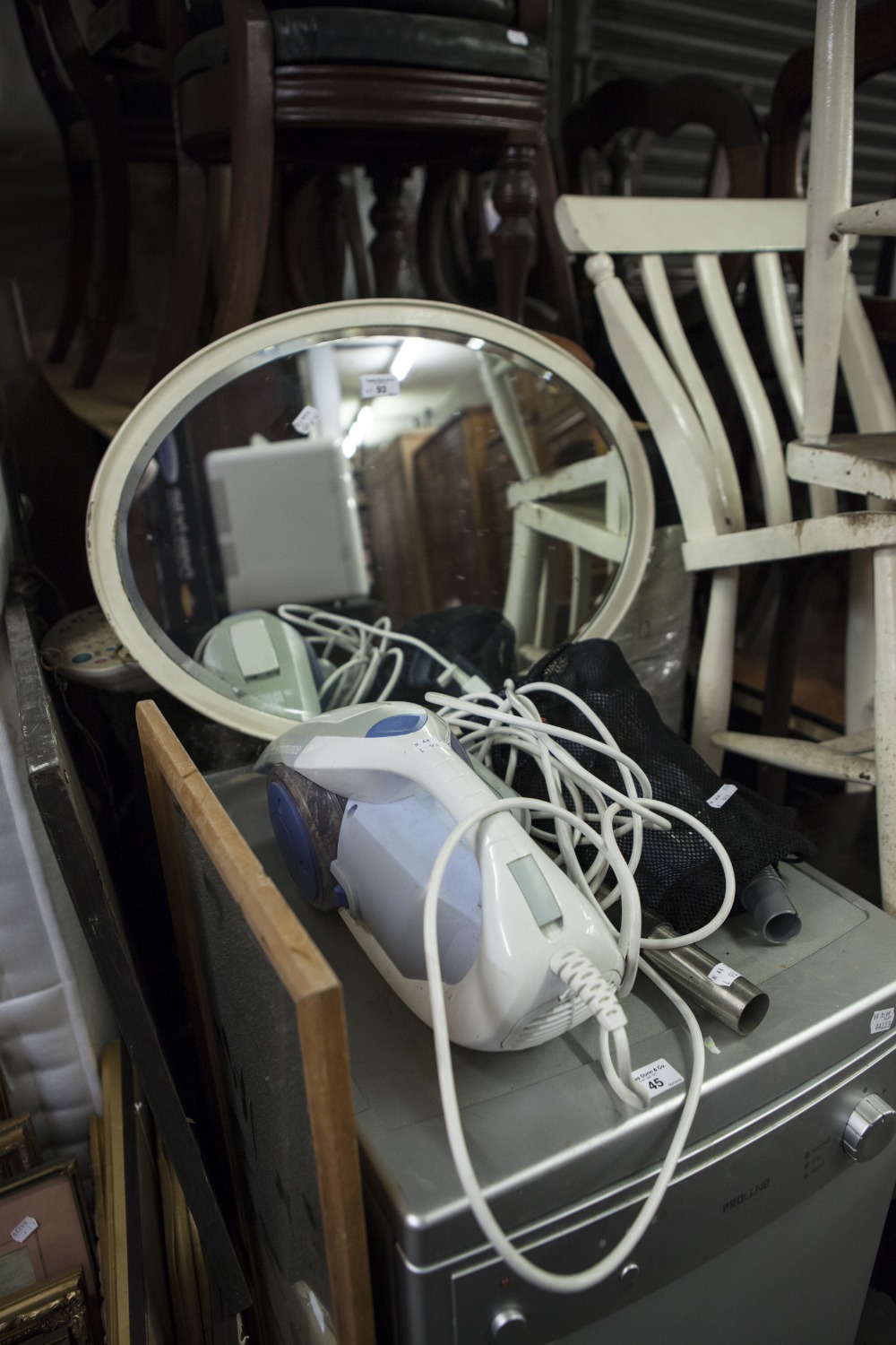 AN OVAL BEVELLED EDGE WALL MIRROR, IN WHITE FRAME AND A BLACK AND DECKER 'CYCLONE' HAND VACUUM