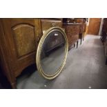 A GILT FRAMED OVAL MIRROR, PAINTED BENTWOOD SINGLE CHAIR, AND A TWO TIER TABLE WITH BASE DRAWER (