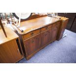 A MAHOGANY SIDEBOARD, WITH THREE DRAWERS, OVER THREE MOULDED PANEL DOORS, THE BRASS DROP HANDLES, ON