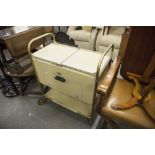 AN EARLY 1960'S CREAM ENAMEL AND GILT TUBULAR METAL HEATED FOOD TROLLEY, WITH ORIGINAL LIDDED DISHES