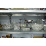 A COLLECTION OF GLASS WARES TO INCLUDE A JELLY MOULD, A CAKE STAND, CANDLESTICKS, TRINKET DISHES,