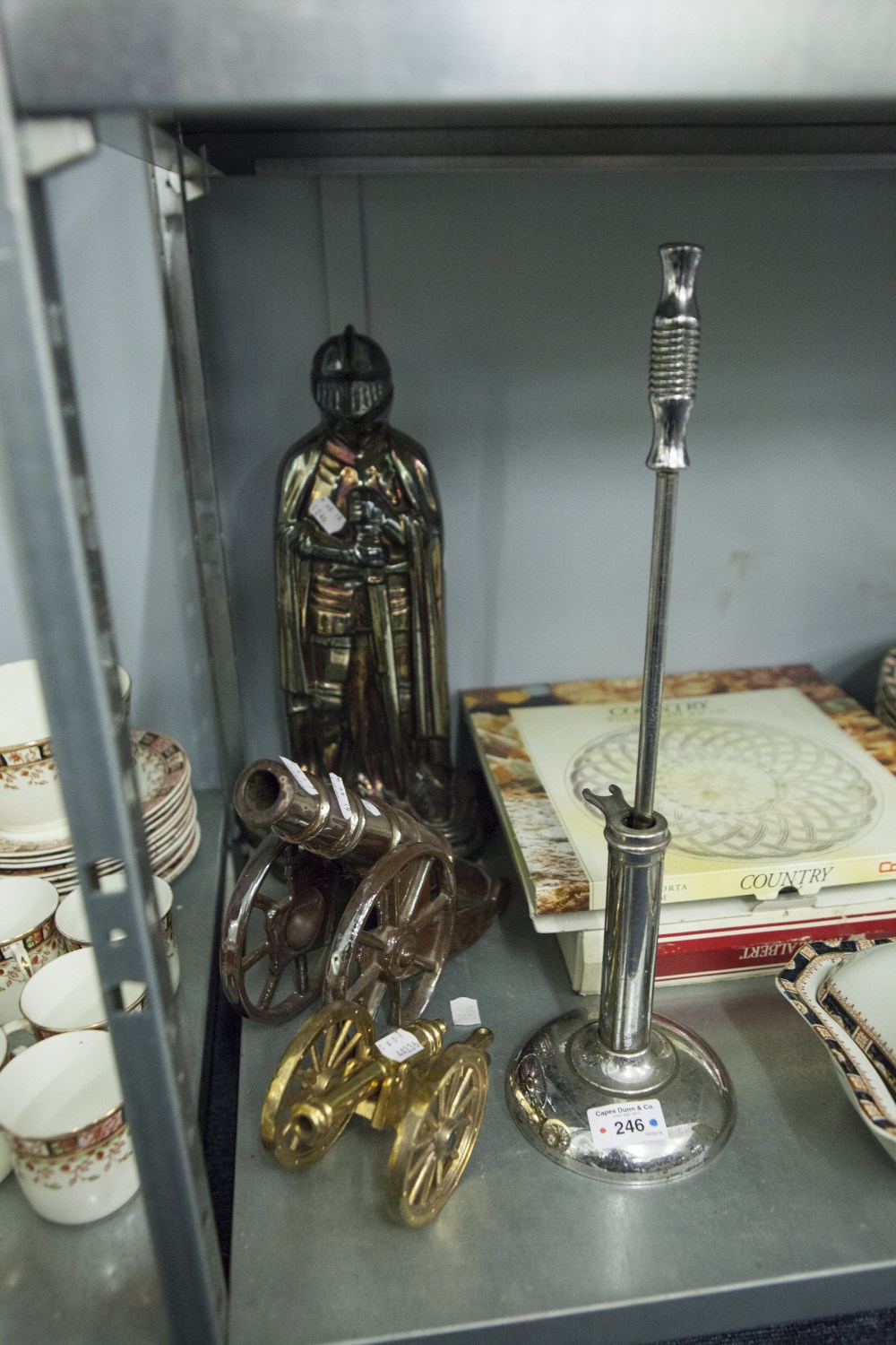 OXIDISED METAL KNIGHT PATTERN POKER STAND WITH HINGED HELMET, A STEEL POKER ON STAND AND TWO METAL