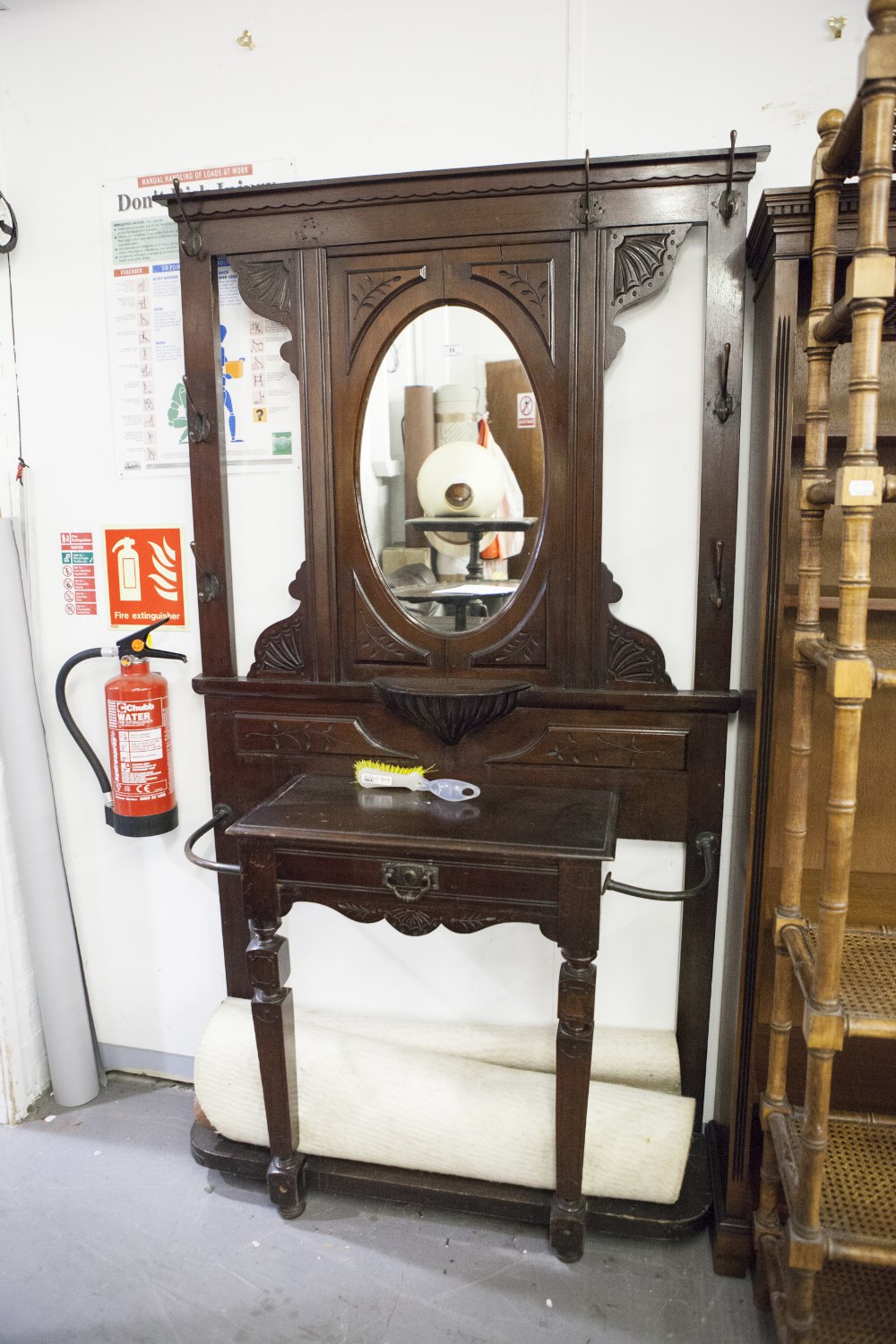 A VICTORIAN MAHOGANY HALL STAND, THE CENTRAL OVAL MIRROR OVAL SHELF, CARVED DECORATION THROUGH-