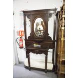 A VICTORIAN MAHOGANY HALL STAND, THE CENTRAL OVAL MIRROR OVAL SHELF, CARVED DECORATION THROUGH-