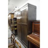 A QUARTERED MAHOGANY LINEN CUPBOARD WITH TWO DOORS, ON SQUARE TAPERING ELGS AND SPADE FEET, 2'2"