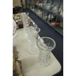 A COLLECTION OF CUT GLASS WARES, TO INCLUDE; FOUR VASES AND A DECANTER WITH A STOPPER (5)