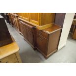 A MAHOGANY SIDEBOARD, WITH THREE DRAWERS, OVER THREE MOULDED PANEL DOORS, THE BRASS DROP HANDLES, ON