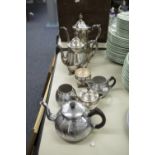 A SILVER PLATE TEA/COFFEE SERVICE OF FOUR PIECES AND ANOTHER OF THREE PIECES