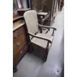 AN EARLY TWENTIETH CENTURY OAK COMMODE CHAIR, CANED BACK AND SEAT WITH ORIGINAL COMMODE AND AN OAK