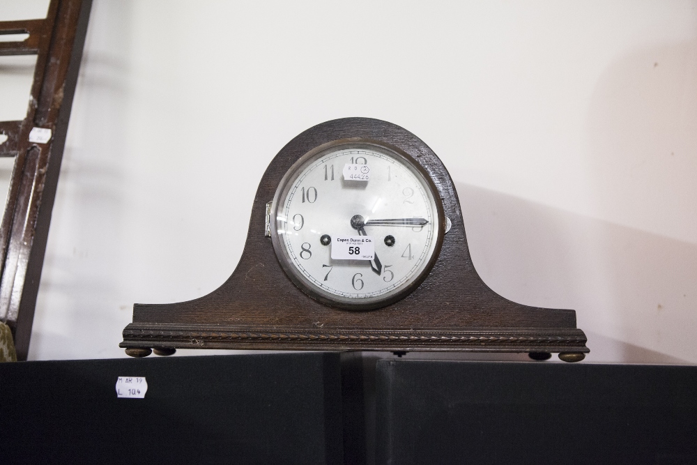 A TWENTIETH CENTURY OAK CASED NAPOLEONS HAT SHAPED MANTEL CLOCK, SILVERED DIAL AND BLACK NUMERALS