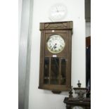 AN OAK CASED WELLINGTON WALL CLOCK