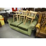 AN EARLY TWENTIETH CENTURY SETTEE WITH FALL-END, RE-UPHOLSTERED IN GREEN VELVET