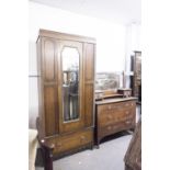 AN EARLY TWENTIETH CENTURY OAK DRESSING CHEST, THE SHAPED SWING MIRROR ON STAND WITH DRAWER TO