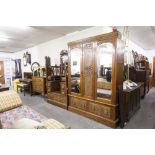 A VICTORIAN BEDROOM SUITE OF THREE PIECES VIZ, A TRIPLE WARDROBE WITH MIRRORS TO EACH DOOR, TWO