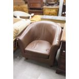 A MODERN TUB SHAPED LOUNGE CHAIR, COVERED IN DARK BROWN HIDE