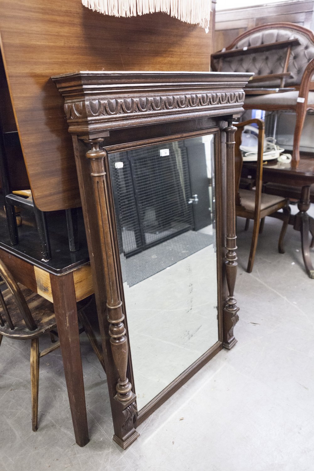 AN EARLY TWENTIETH CENTURY CARVED OAK PIER MIRROR WITH BEVELLED EDGE RECTANGULAR PLATE, FANCY