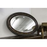 OVAL BEVELLED EDGE WALL MIRROR IN CARVED FRAME