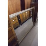 A LARGE RECTANGULAR BEVELLED EDGE WALL MIRROR, IN GILT FRAME