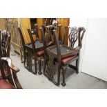 A SET OF FOUR MAHOGANY CHIPPENDALE STYLE DINING CHAIRS WITH RED LEATHER SEATS (4)