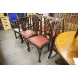 A SET OF FOUR MAHOGANY CHIPPENDALE STYLE DINING CHAIRS WITH RED LEATHER SEATS (4)