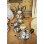 A SILVER PLATE TEA/COFFEE SERVICE OF FOUR PIECES AND ANOTHER OF THREE PIECES