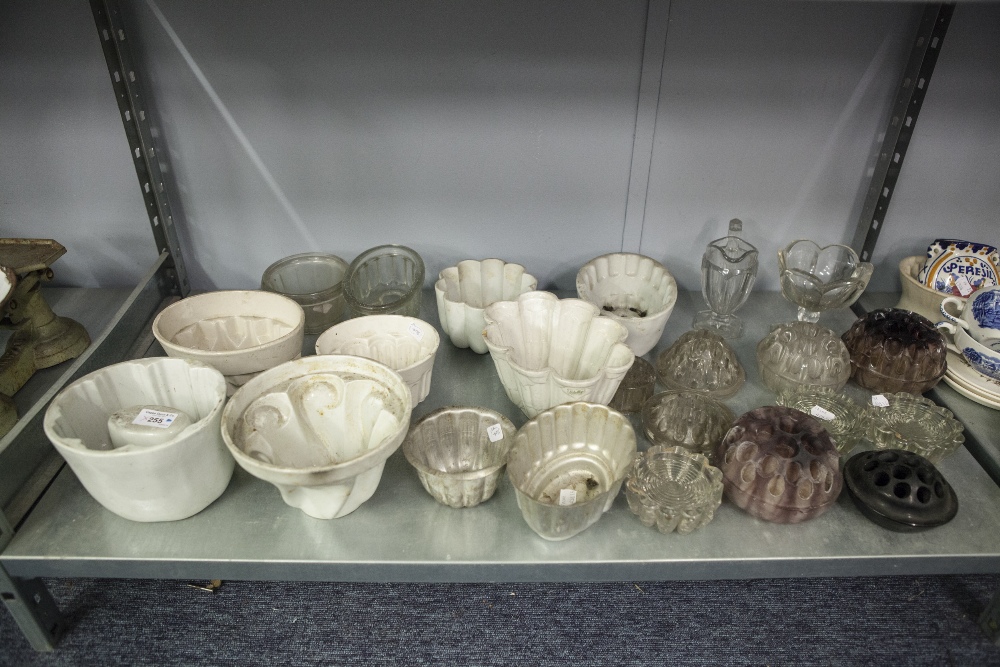 ELEVEN VARIOUS POTTERY, GLASS AND METAL JELLY MOULDS