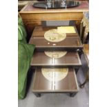 A NEST OF THREE RECTANGULAR COFFEE TABLES, WITH TERRESTRIAL MAP TOPS, GLASS PROTECTORS, BRASS FRAMED