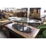 A MODERN GLASS TOPPED COFFEE TABLE