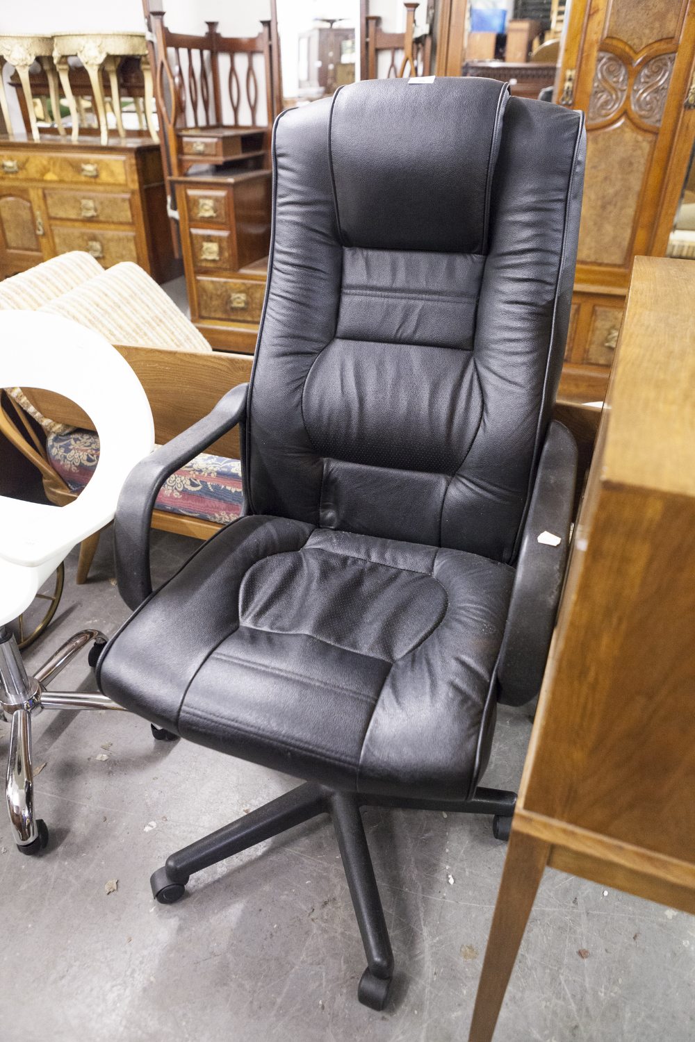 AN EXECUTIVE BLACK HIDE, HIGH- BACKED, REVOLVING ARMCHAIR