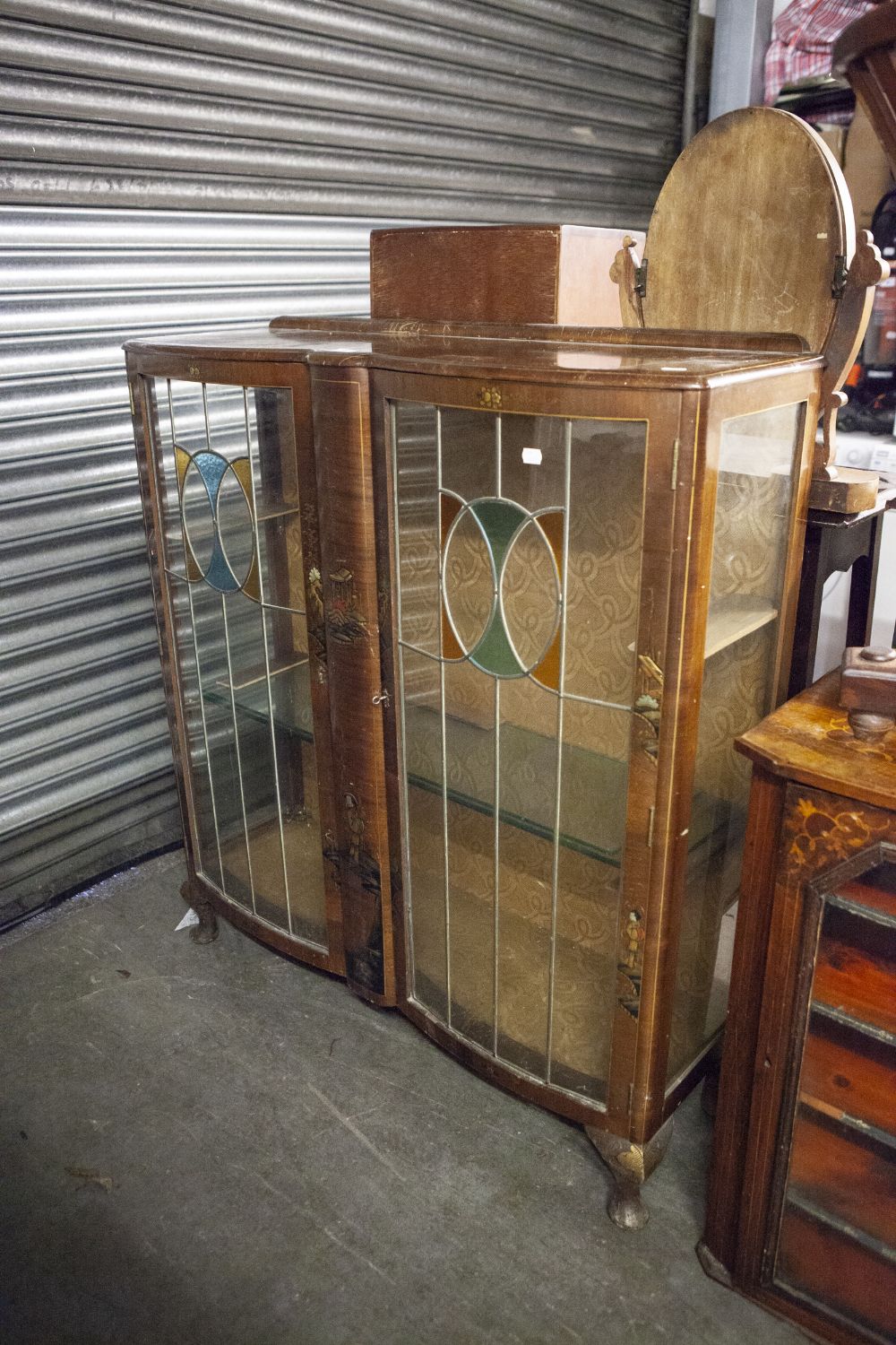 A TWO DOOR GLASS DISPLAY CABINET WITH COLOURED GLASS PANELS AND ORIENTAL DECORATION (A.F.)