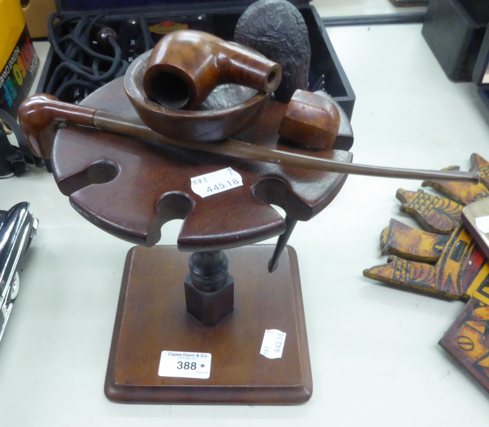 MAHOGANY PIPE STAND AND THREE PIPES AND A PIPE BOWL