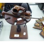 MAHOGANY PIPE STAND AND THREE PIPES AND A PIPE BOWL