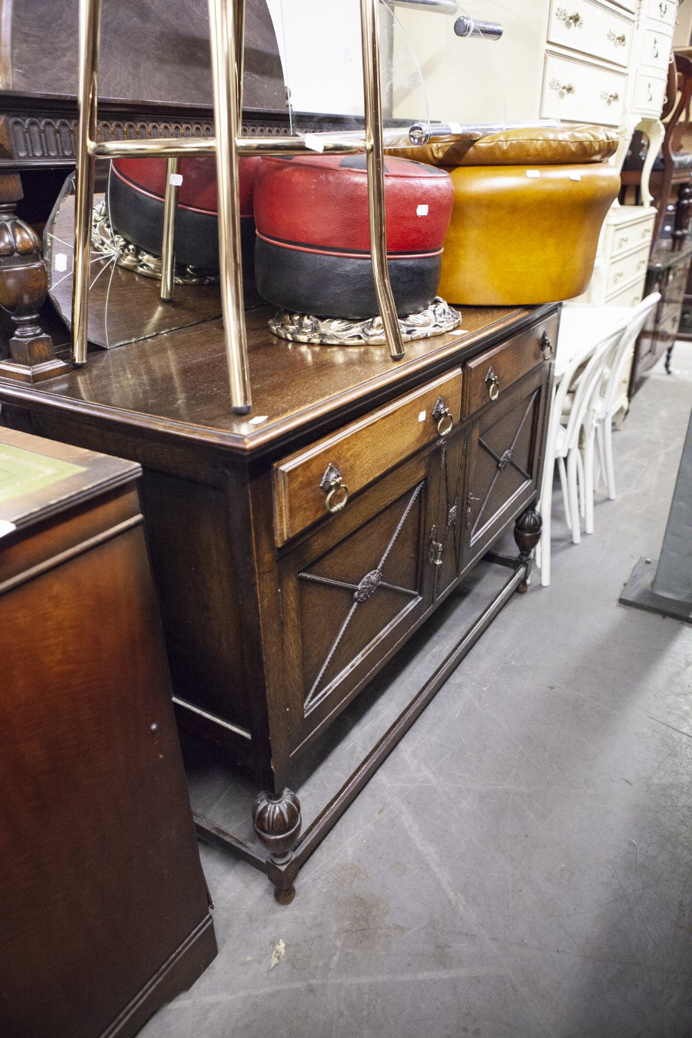 AN EDWARDIAN OAK SIDEBOARD WITH RAISED BACK