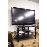 LG 42" FLAT SCREEN TELEVISION RECEIVER WITH DVD PLAYER, REMOTE CONTROLS AND THE THREE TIER STAND