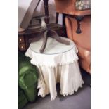 AN OAK CIRCULAR LAMP TABLE WITH FABRIC COVER AND FALL, 24" DIAMETER AND AN OBLONG WALL MIRROR IN