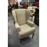 A MODERN WINGED ARMCHAIR, COVERED IN TWEED FABRIC (AS NEW)